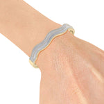 Load image into Gallery viewer, Wave bangle in yellow gold with white diamonds of 3.10 ct in weight